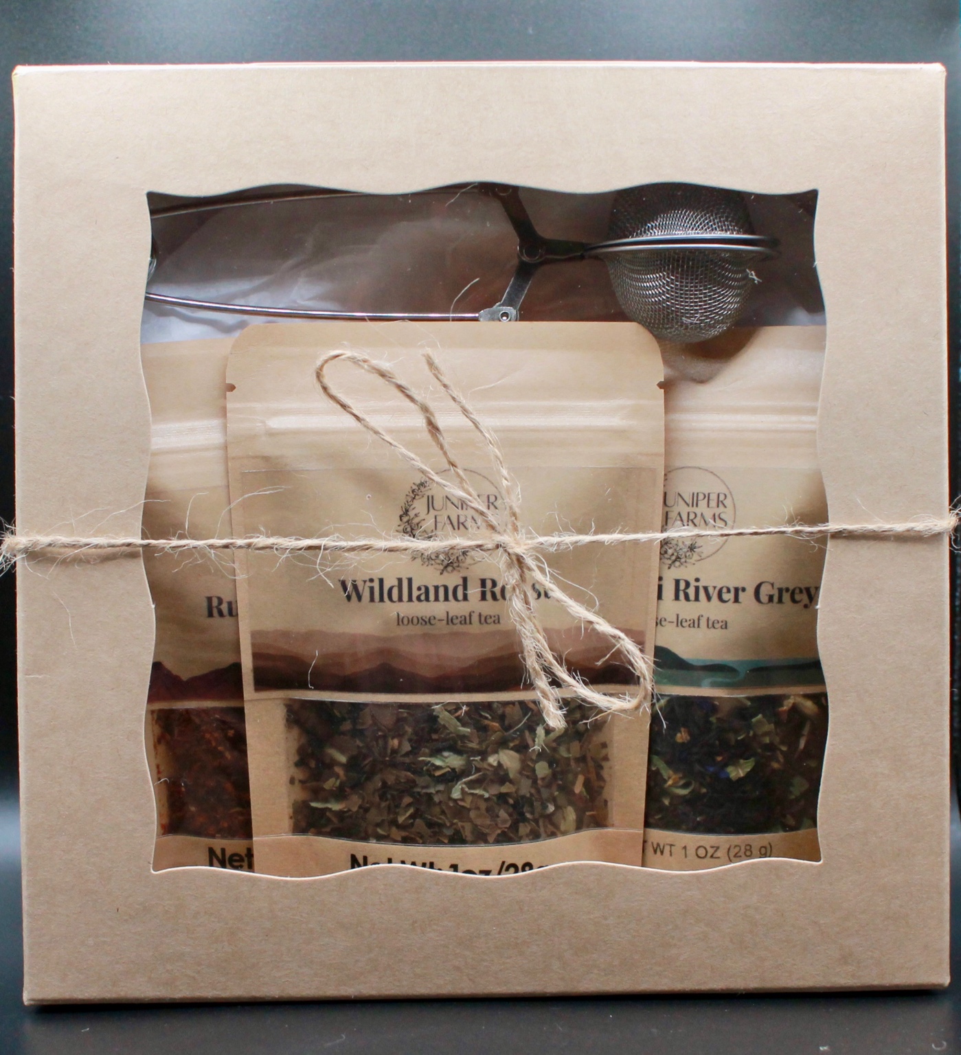 Cabin Collection gift box containing Ruby Mountain, Wildland Roast, Missouri River Grey, and a tea infuser