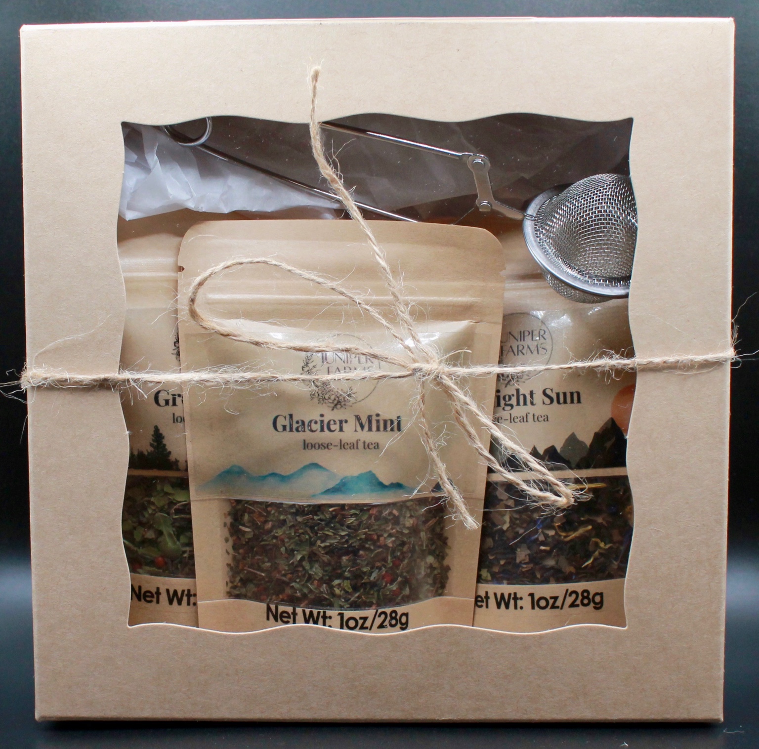 Trail Collection gift box containing Glacier Mint, Green Fire, Midnight Sun, and a tea infuser